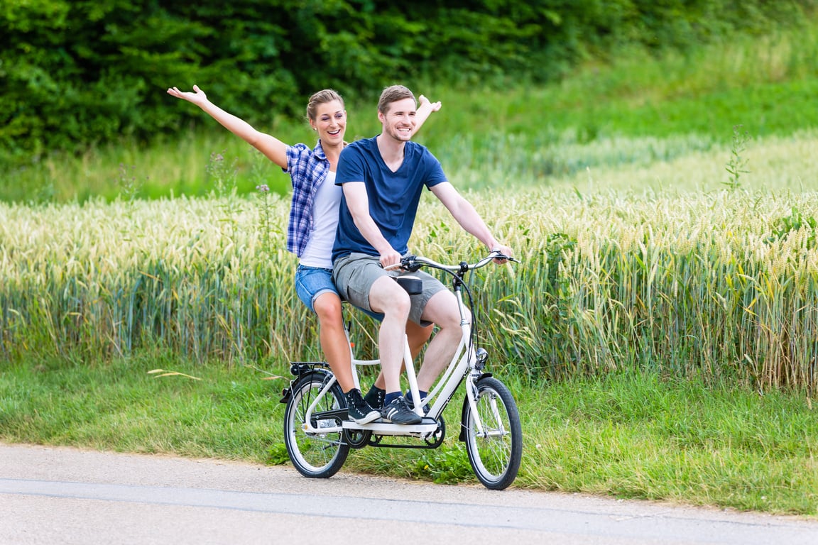 Couple Riding Tandem Bike Together